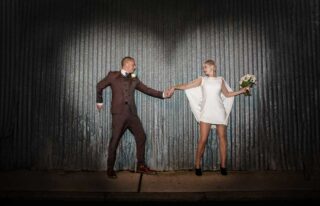 Hoxton wedding shot against corrugated iron
