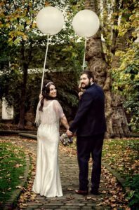 newlyweds turn round for photo on Islington footpath