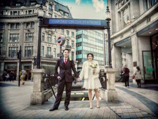 Oxford Circus wedding day couple holding hands photo