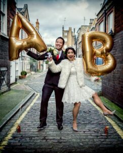 couple with balloons on their central London wedding day