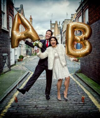 wedding couple pose with balloons on their central London wedding day