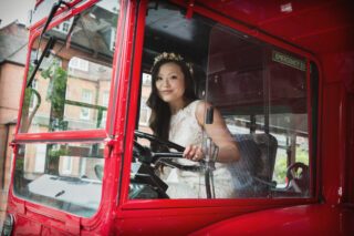 Bride drives route master bus on her London wedding day photo