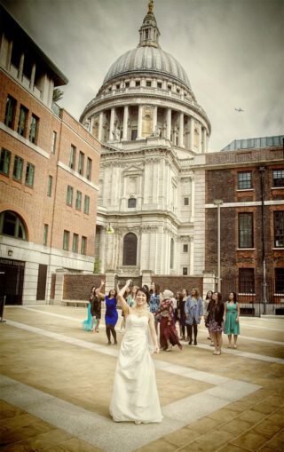 Bridal bouquet toss in front of St Pauls cathedral London image