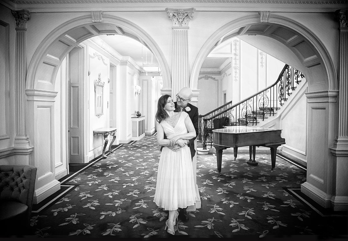 Claridges Hotel wedding photographers couple photo between arches