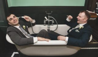 Two grooms in a bath after London wedding
