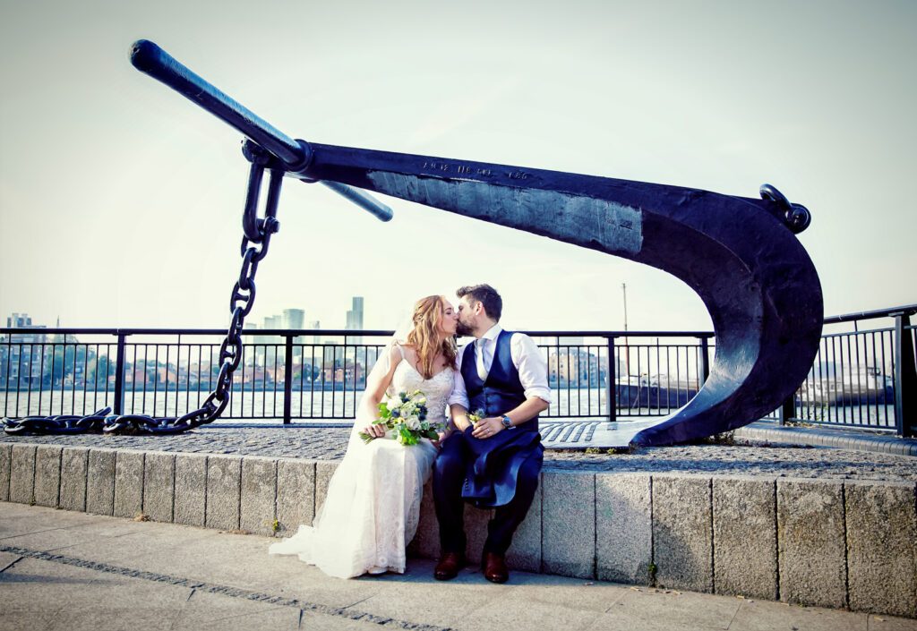 Bride and groom kiss by anchor Cutty Sark Greenwich wedding