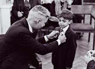 Groom helps pageboy Chelsea Old Town Hall wedding ceremony