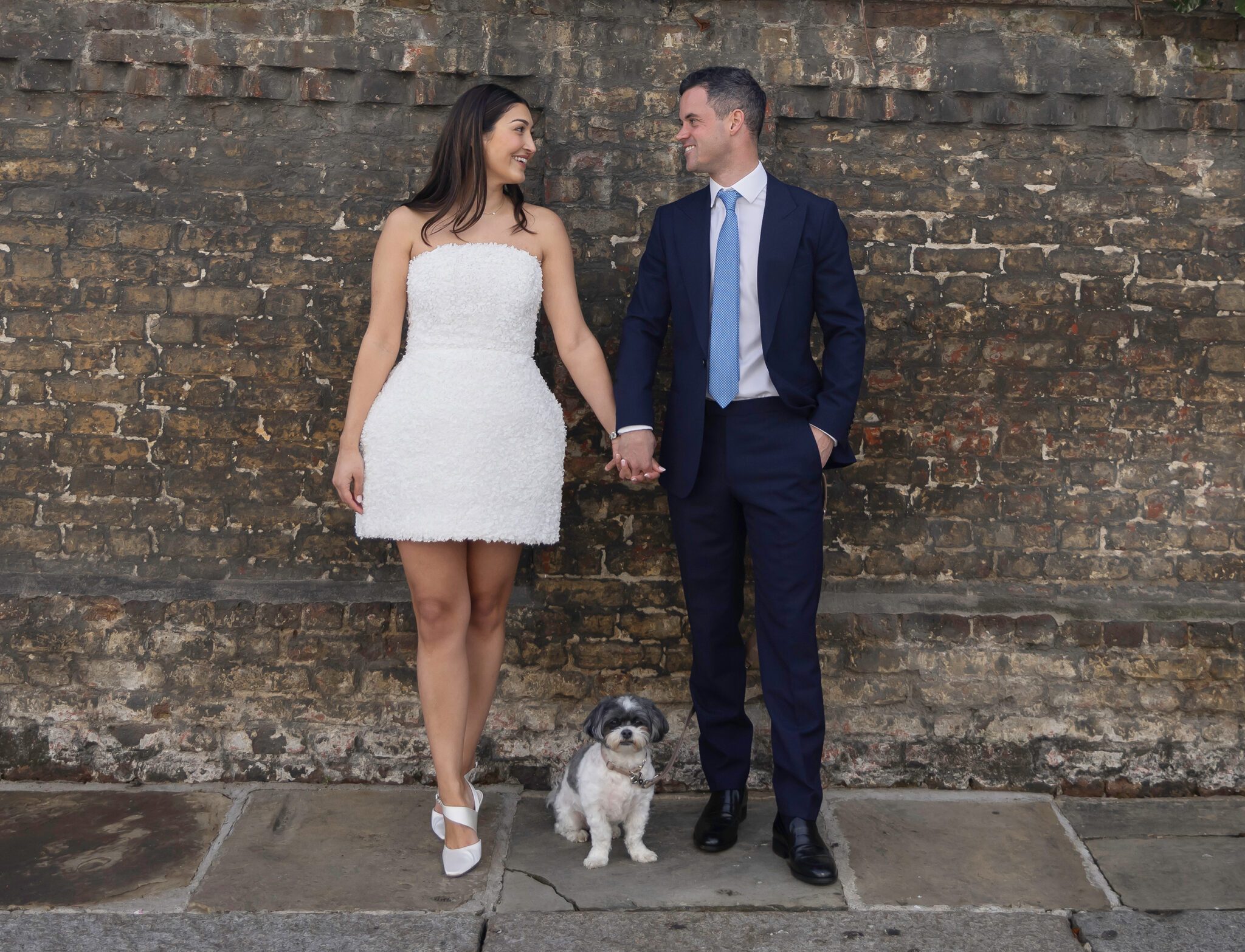 Bride groom and dog by wall Chelsea Old Town Hall