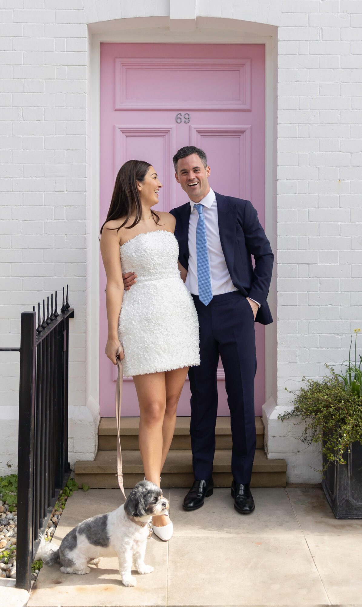 Chelsea Old Town Hall Wedding couple laugh by pink door