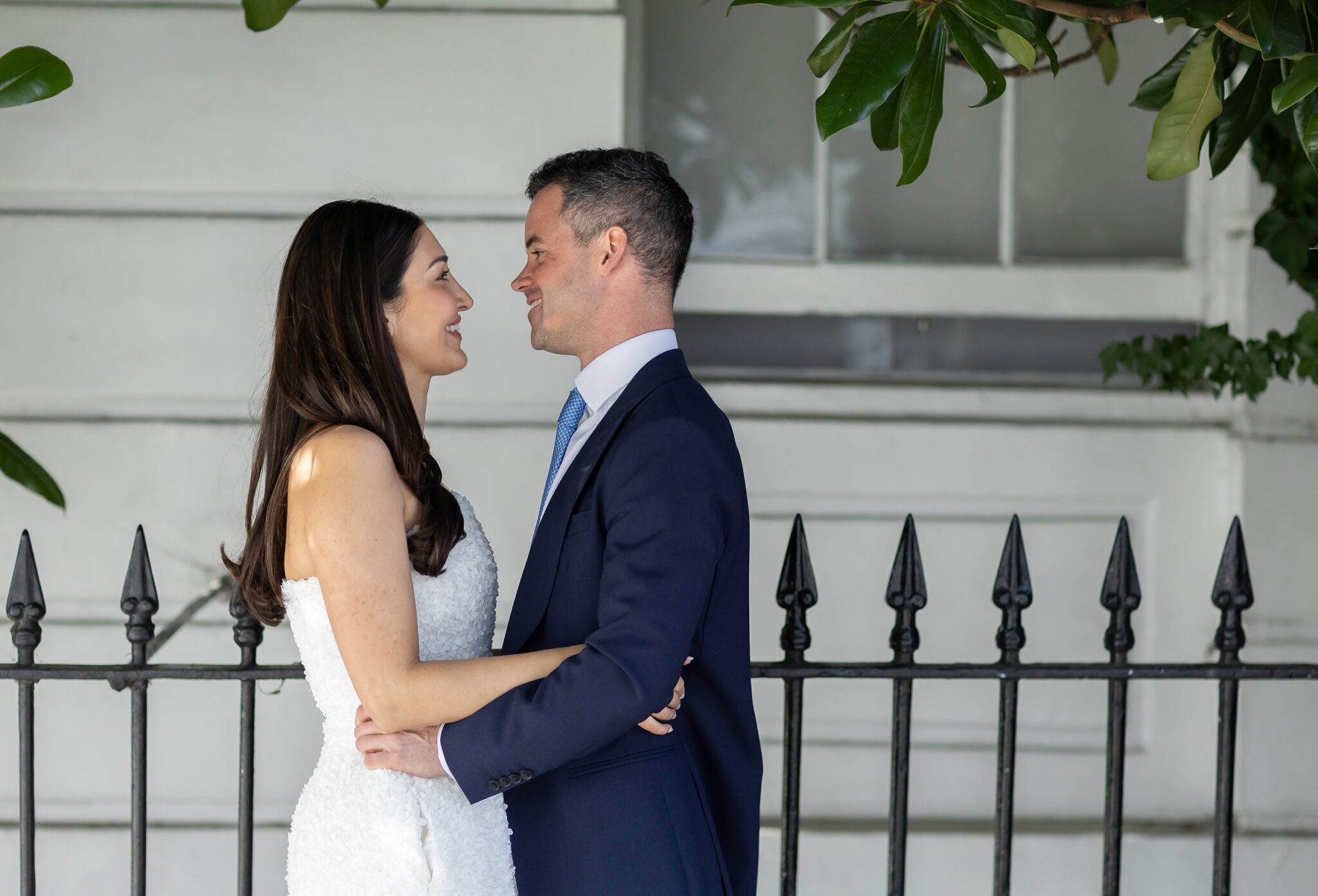 Chelsea Old Town Hall wedding couple by black railings 2