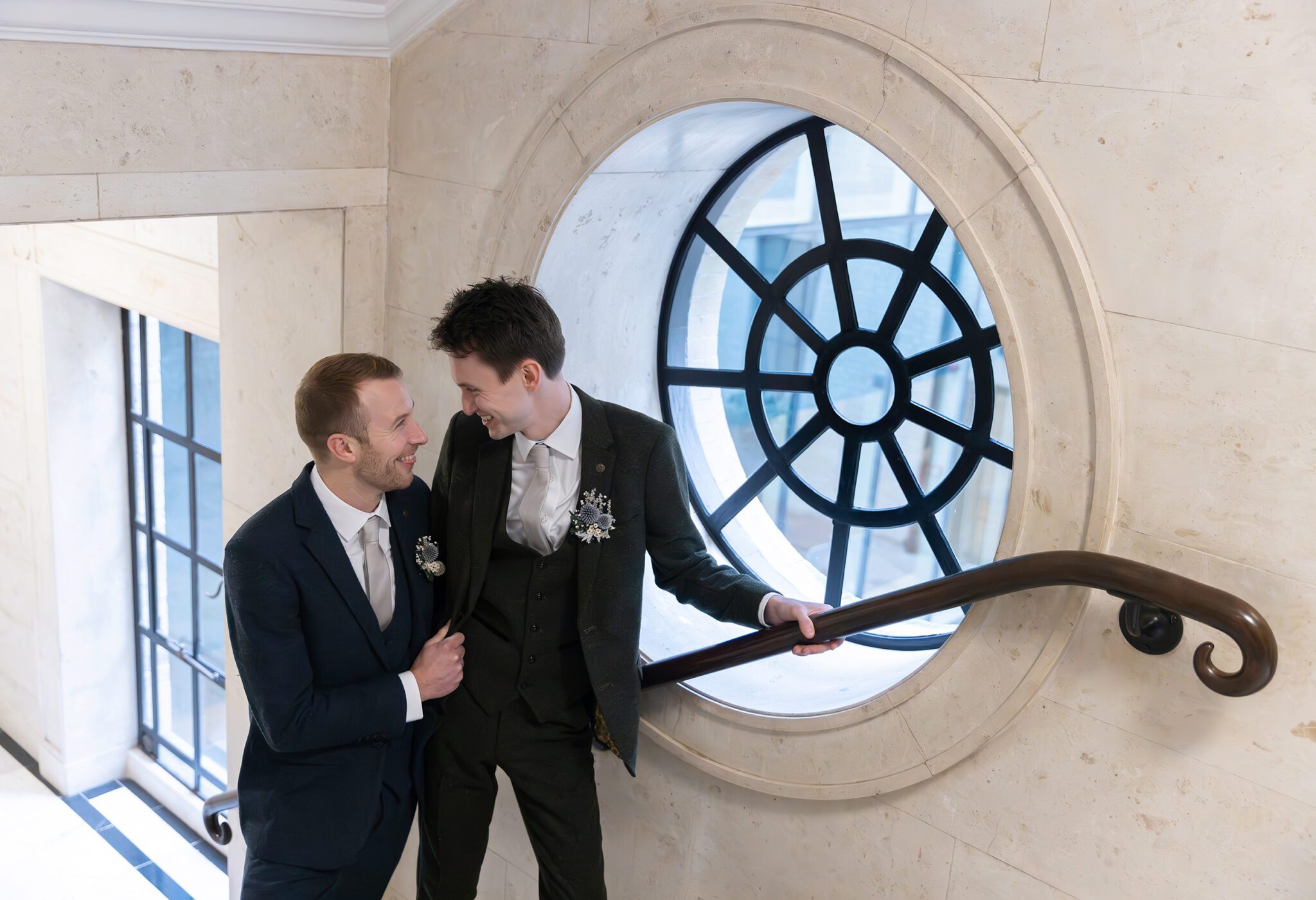 Groom and groom at Old Marylebone Town Hall wedding by rose window