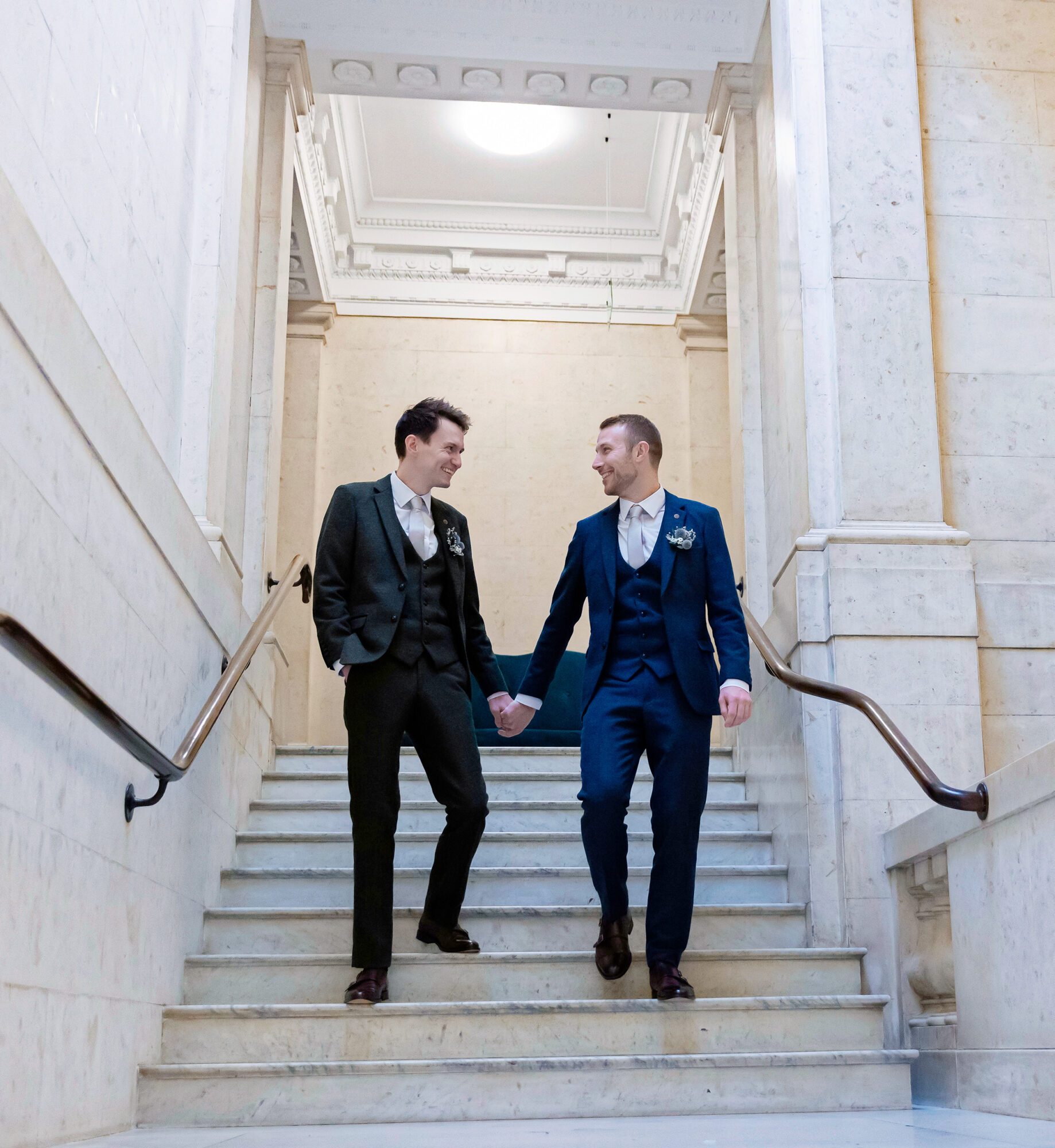 Grooms walking down stairs after Old Marylebone Town Hall Wedding
