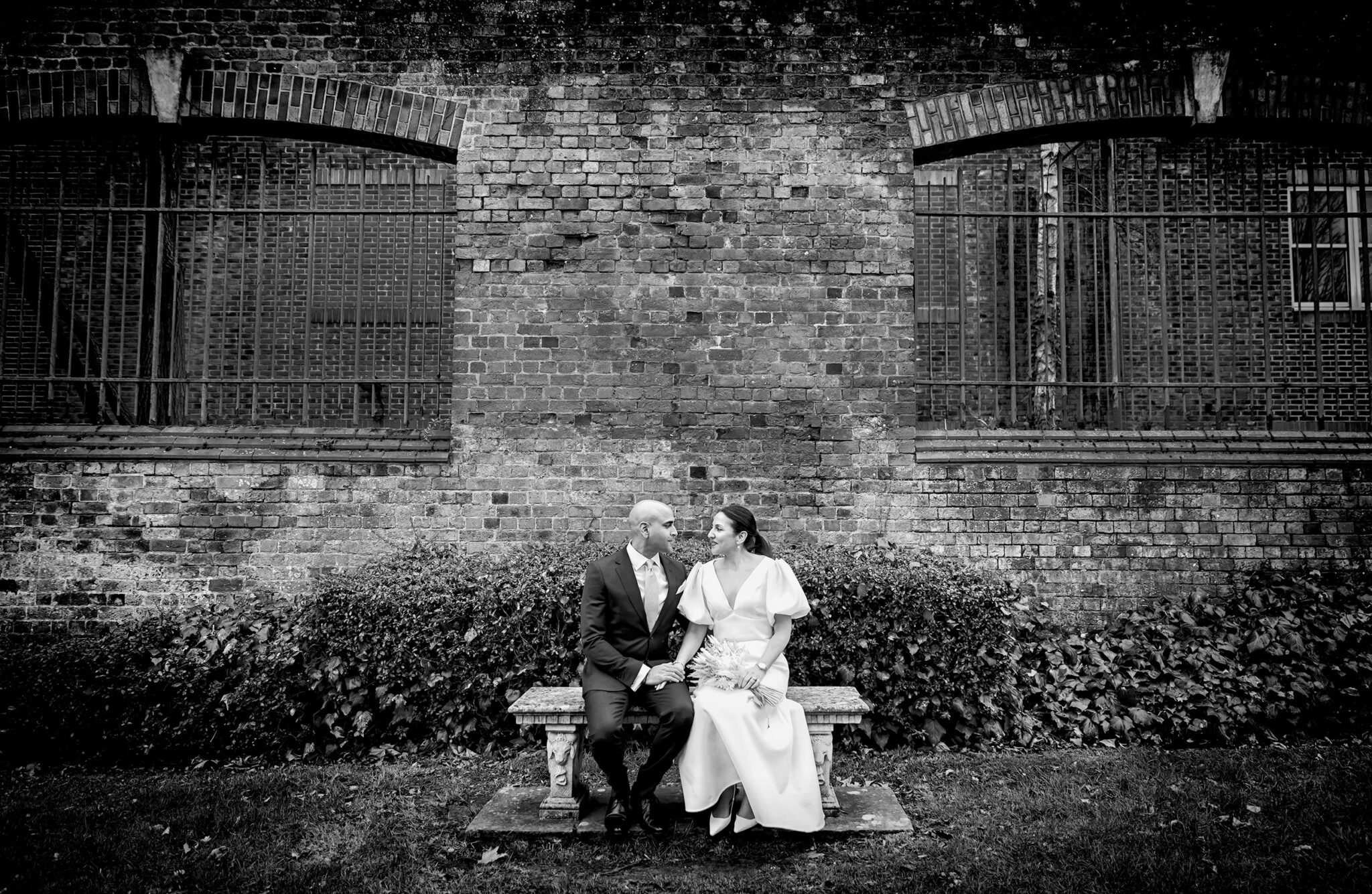 St Albans Registry Office Wedding couple sat on bench in grounds