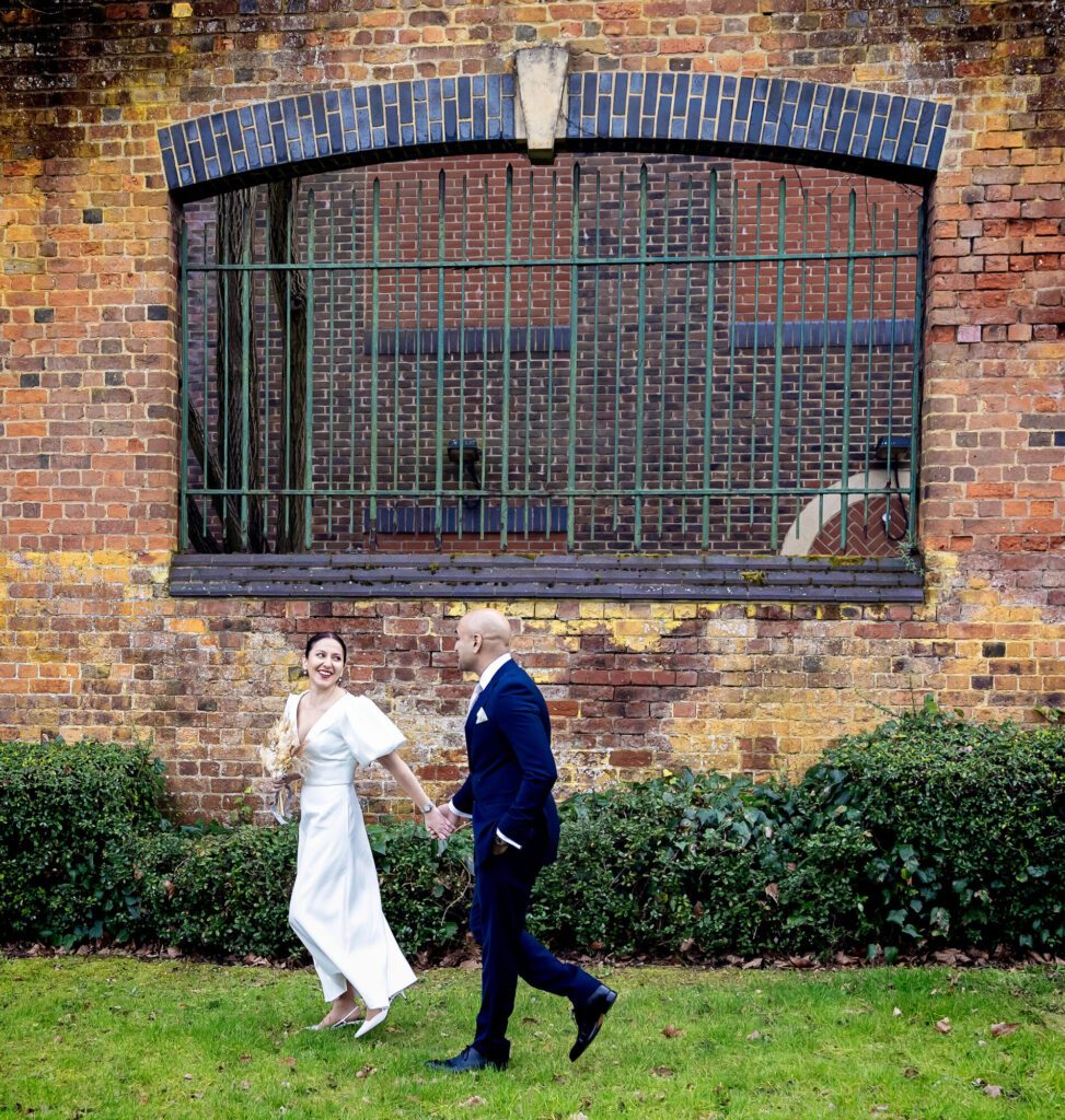 St Albans Registry wedding couple run past wall image