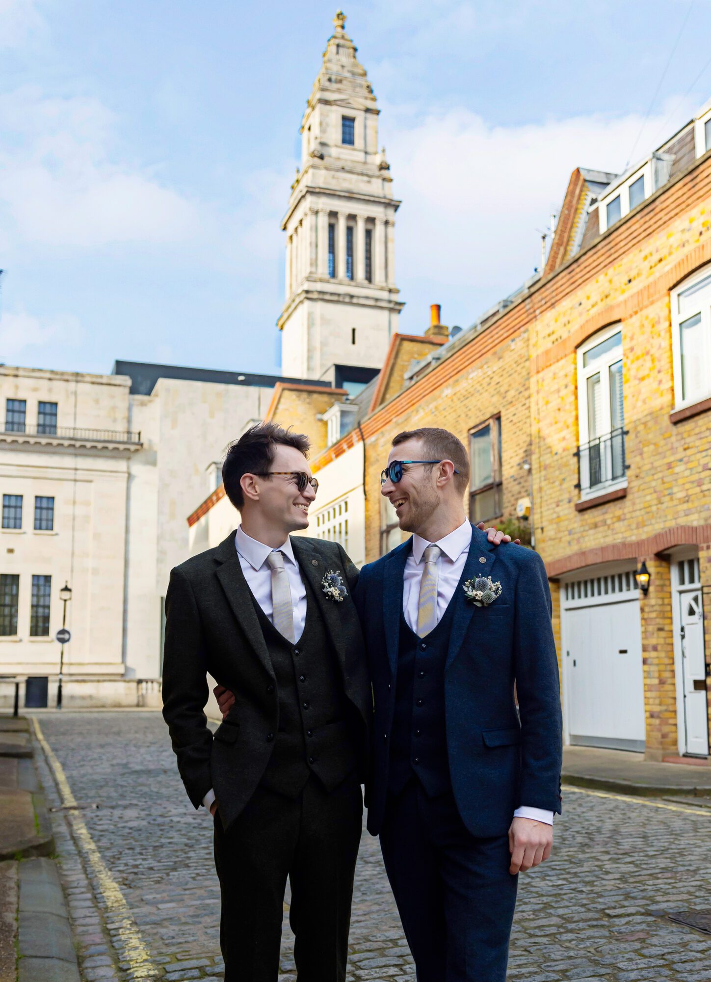 Two grooms together behind Old Marylebone Town Hall