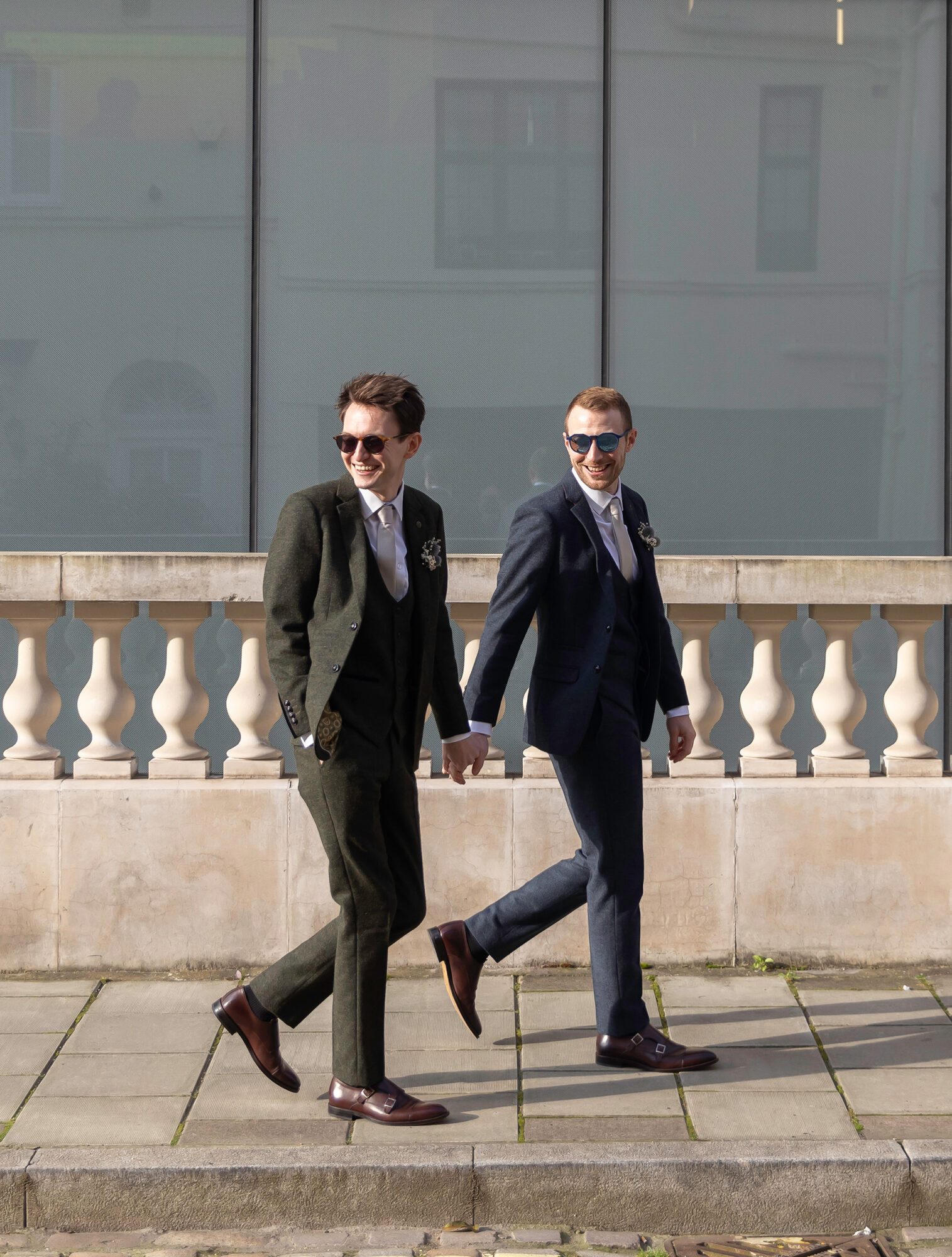 Two grooms walking by Old Marylebone Town Hall London