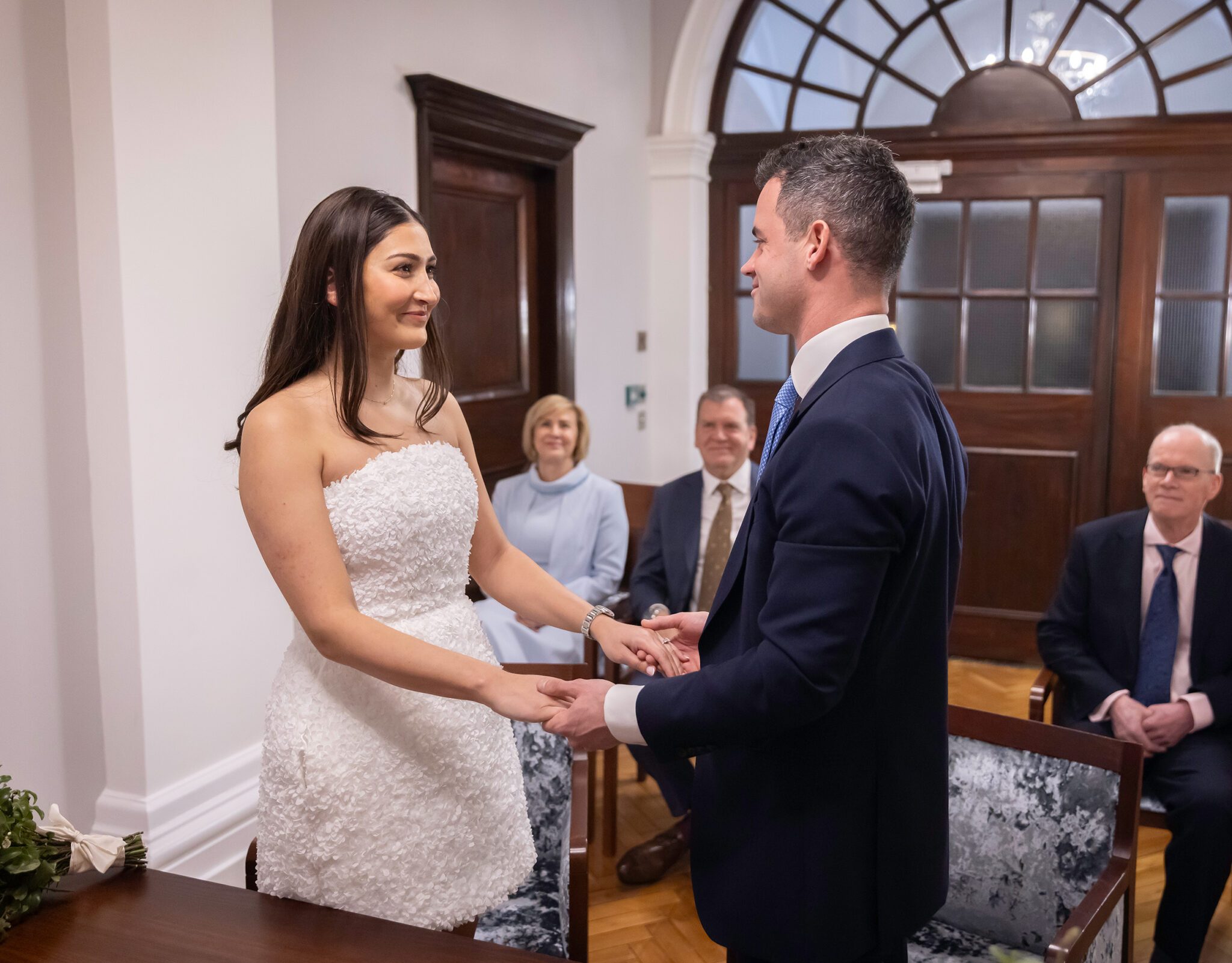 Wedding ceremony couple hold hands Chelsea Old Town Hall