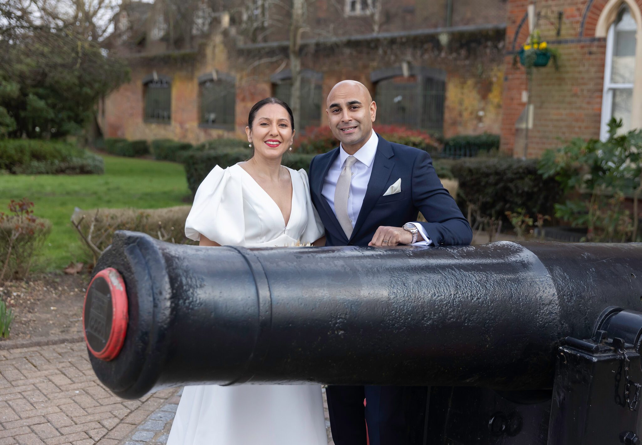 Wedding couple pose by canon at St Albans Registry Hertfordshire