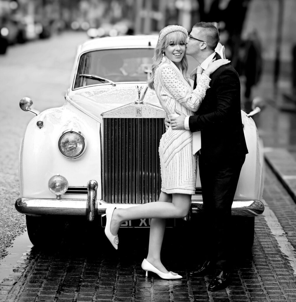 Bride and groom and wedding car by Chelsea Old Town Hall