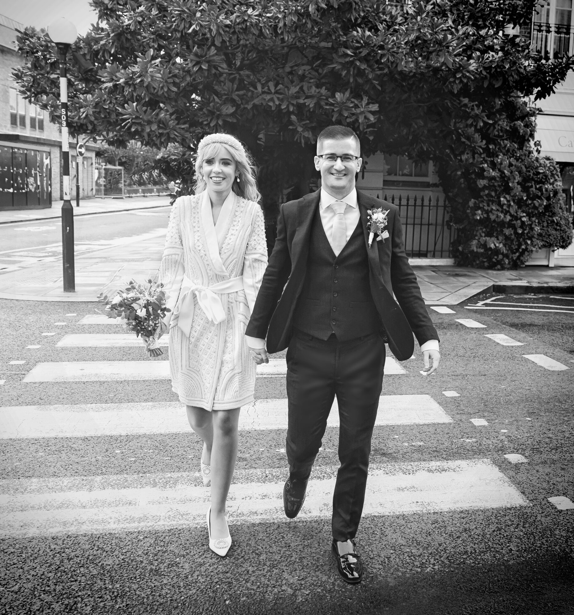 Bride and groom on pedestrian crossing Chelsea