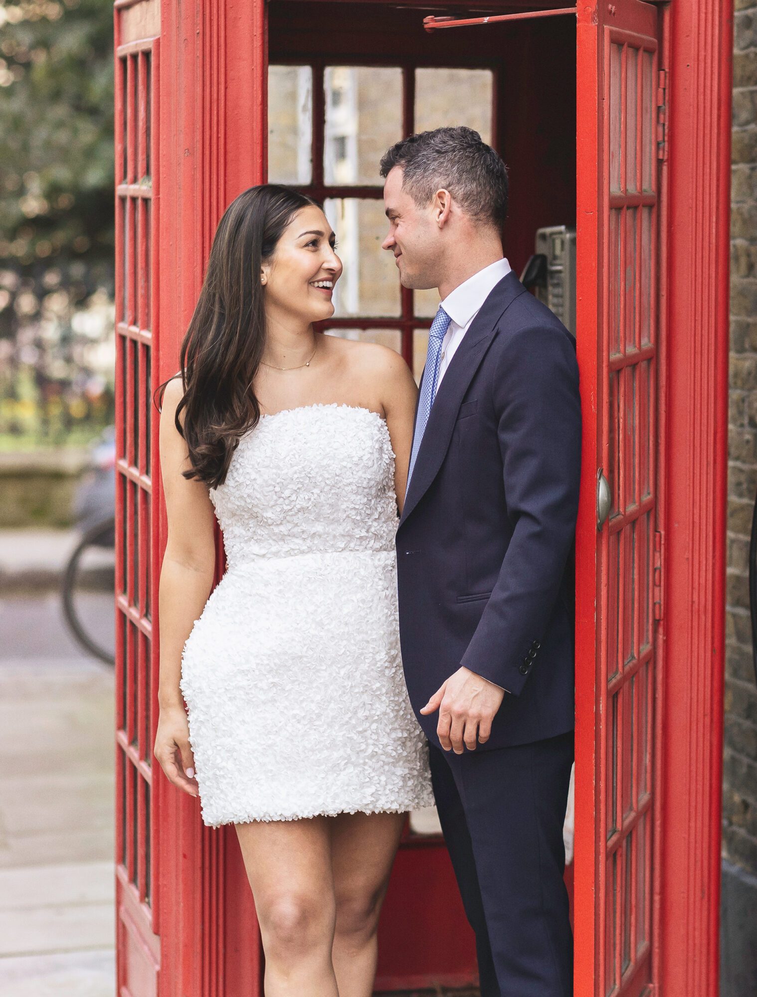 Chelsea Old Town Hall wedding couple by red London phone box