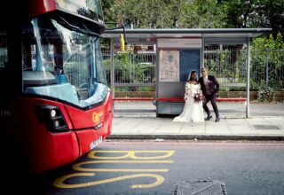 Bride and groom at London bus stop Old Timber Store wedding day