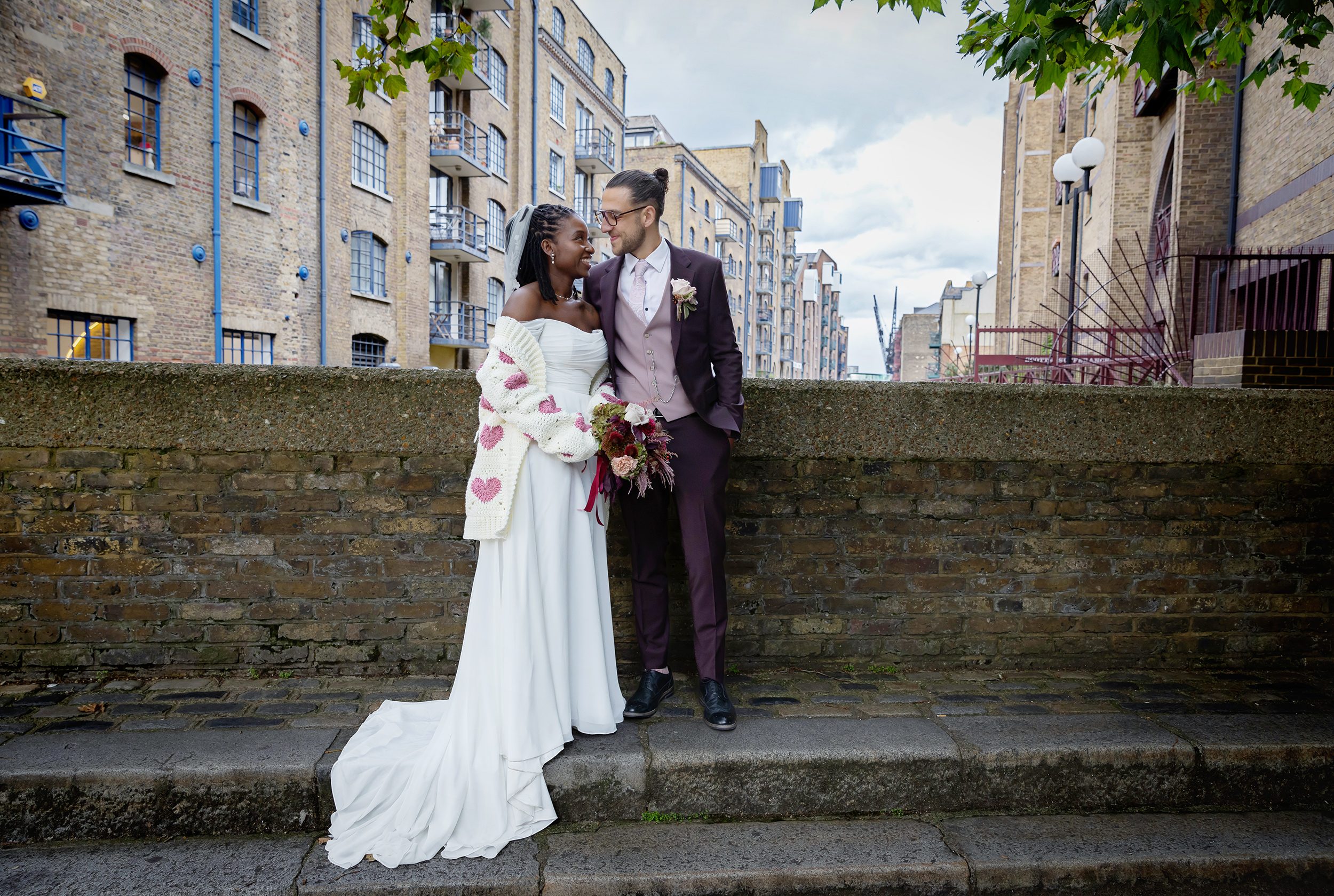 The Old Timber Store wedding couple on step by Thames London