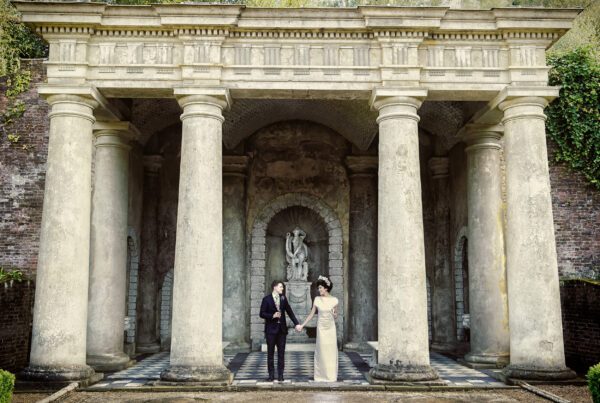 Bride and groom between pillars Wotton House wedding