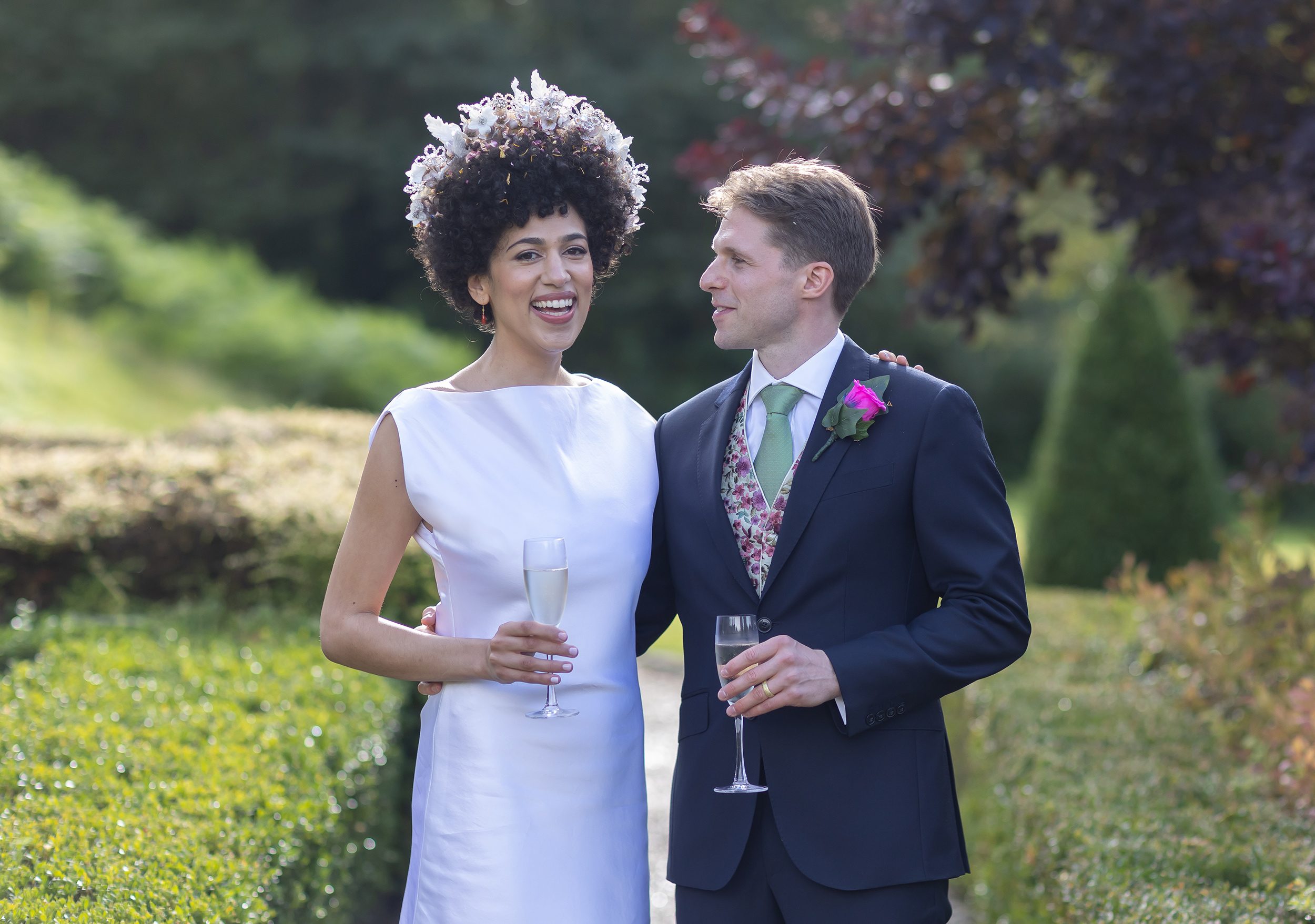 Bride and groom smiling in grounds of Wotton House