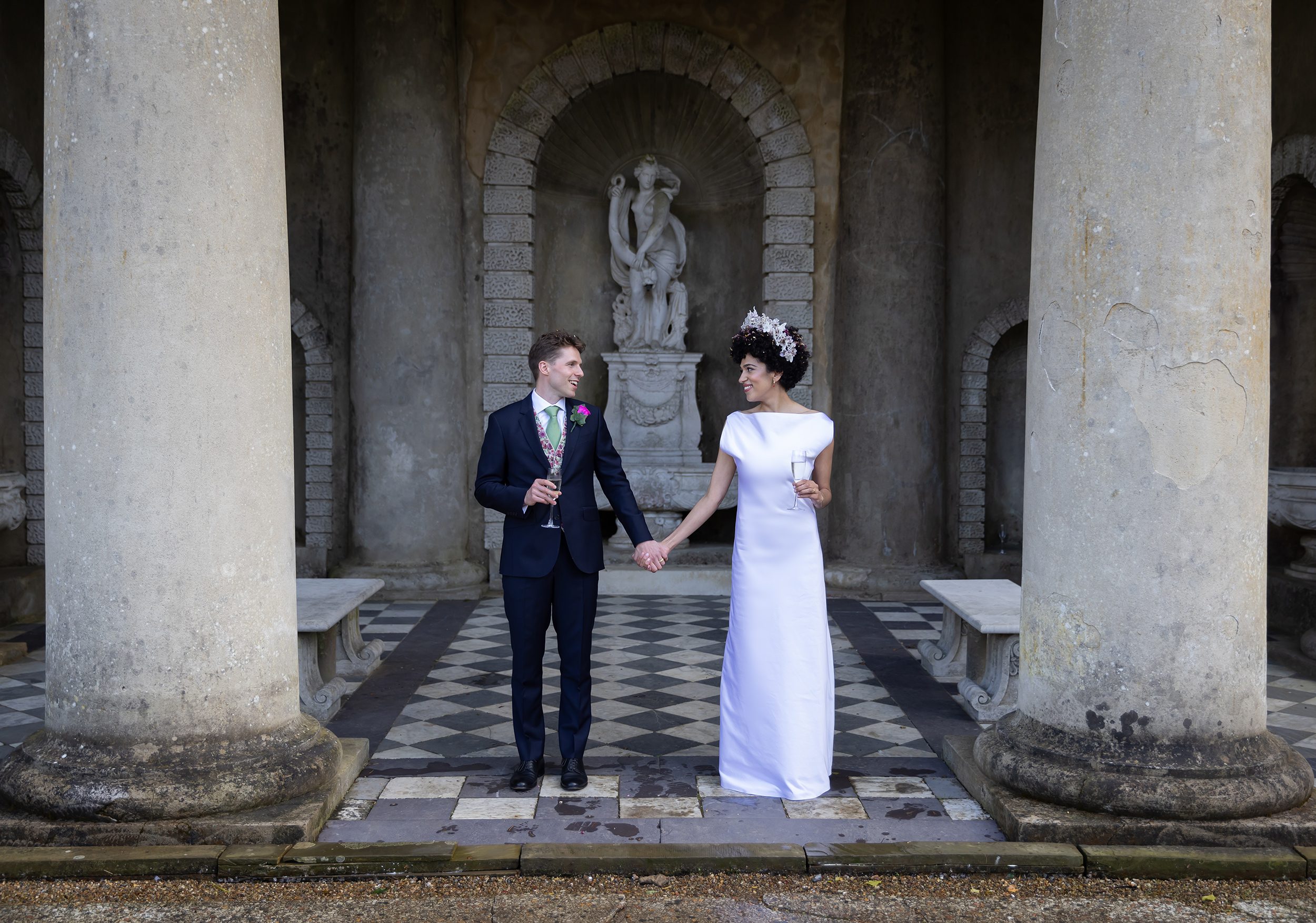 Couple close up between Wotton House pillars on wedding day