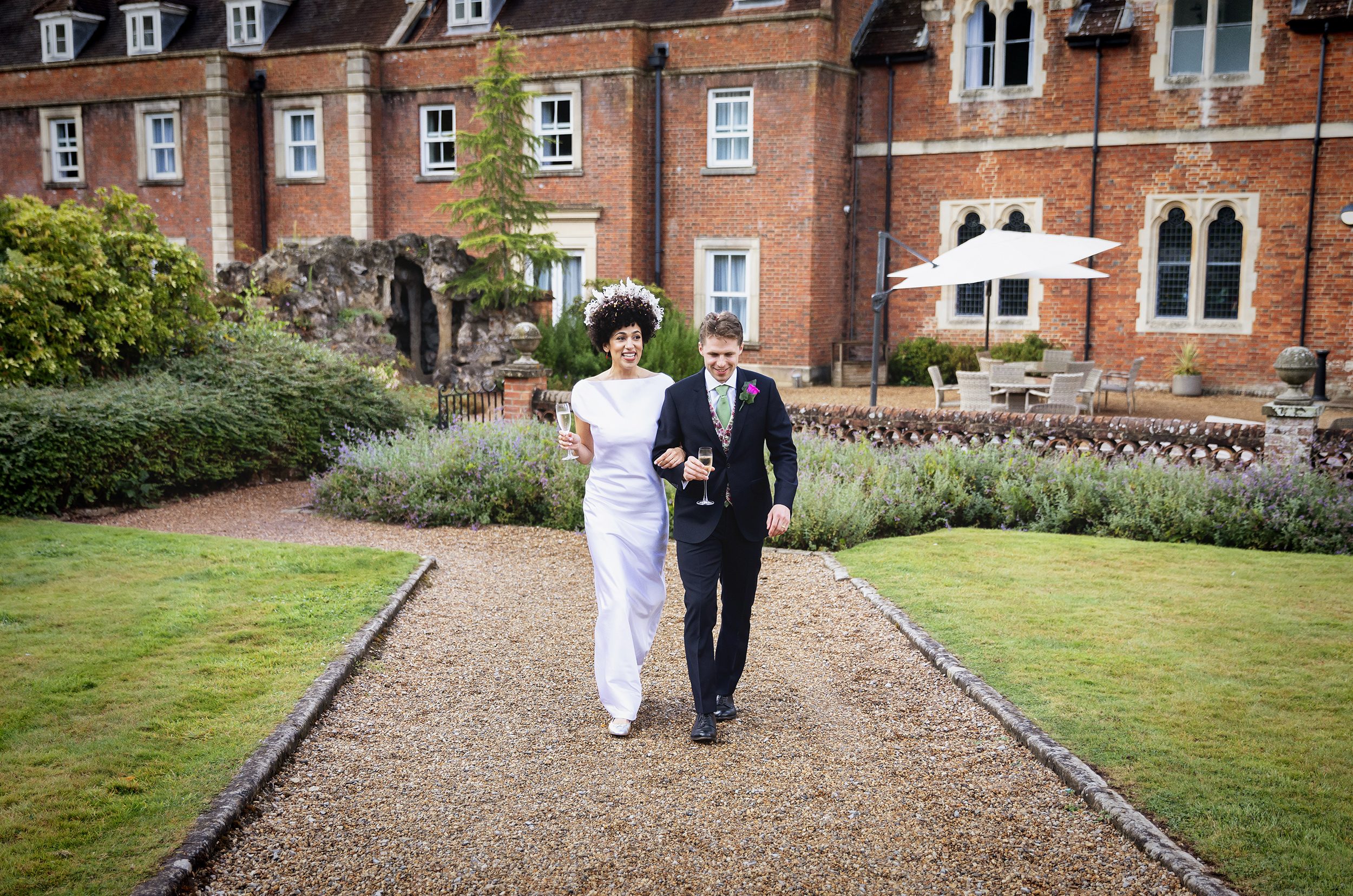 Wedding couple walk in grounds of Wotton House