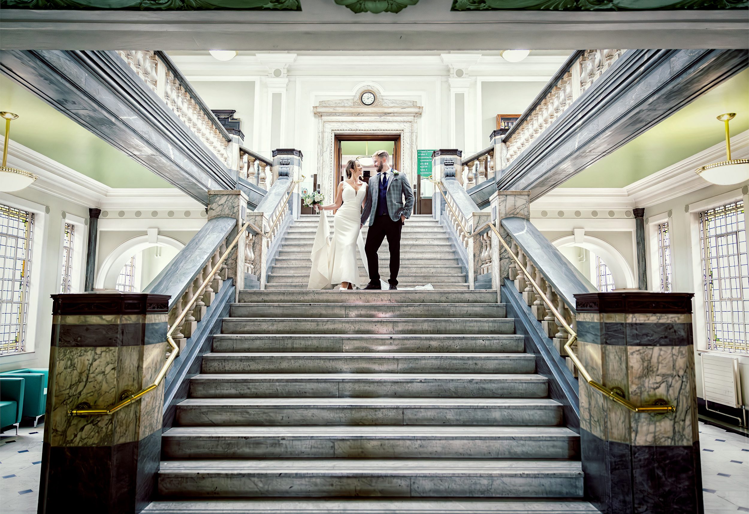 Bride and groom on stairs of Islington Town Hall Wedding