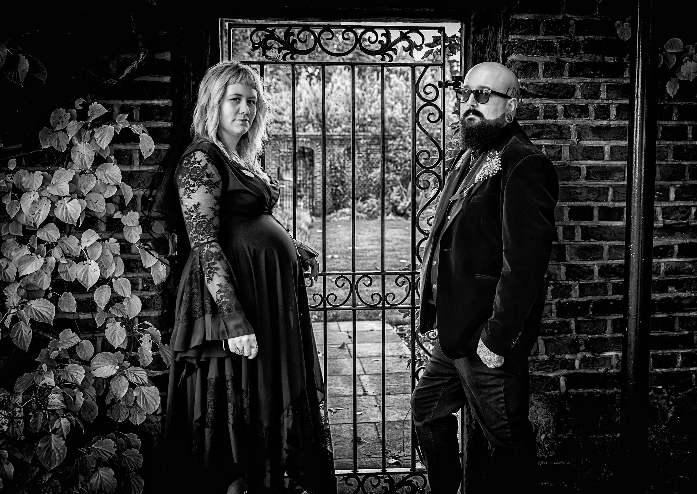 Gothic wedding couple at Hall Place by iron gate