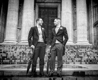 Groom and best man chat outside St Pauls Cathedral wedding