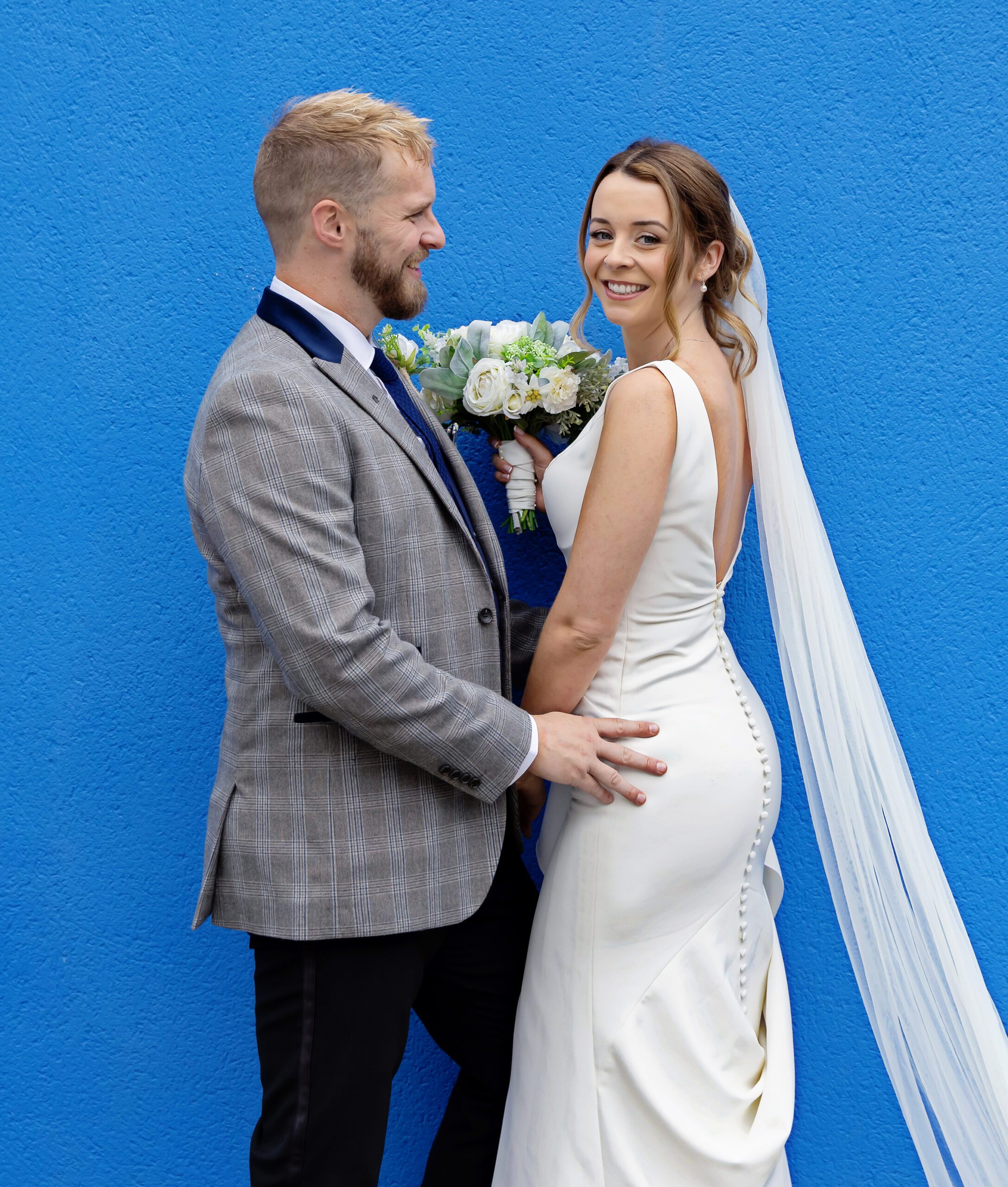 Islington Town Hall Wedding couple by a blue wall image