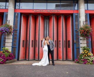 Wedding couple kiss outside Islington Fire Station wedding