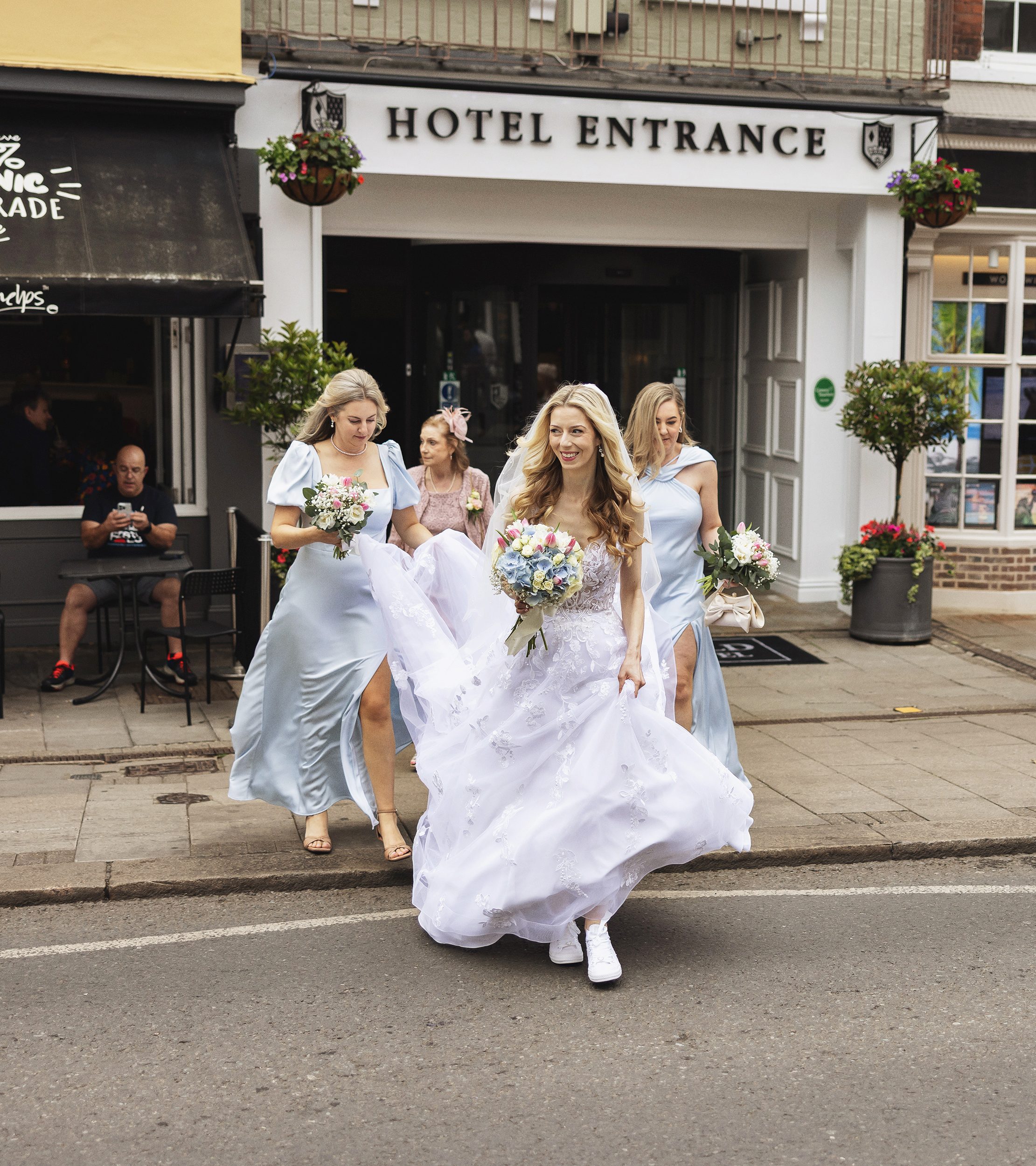Bride and bridesmaids crossing road in Windsor