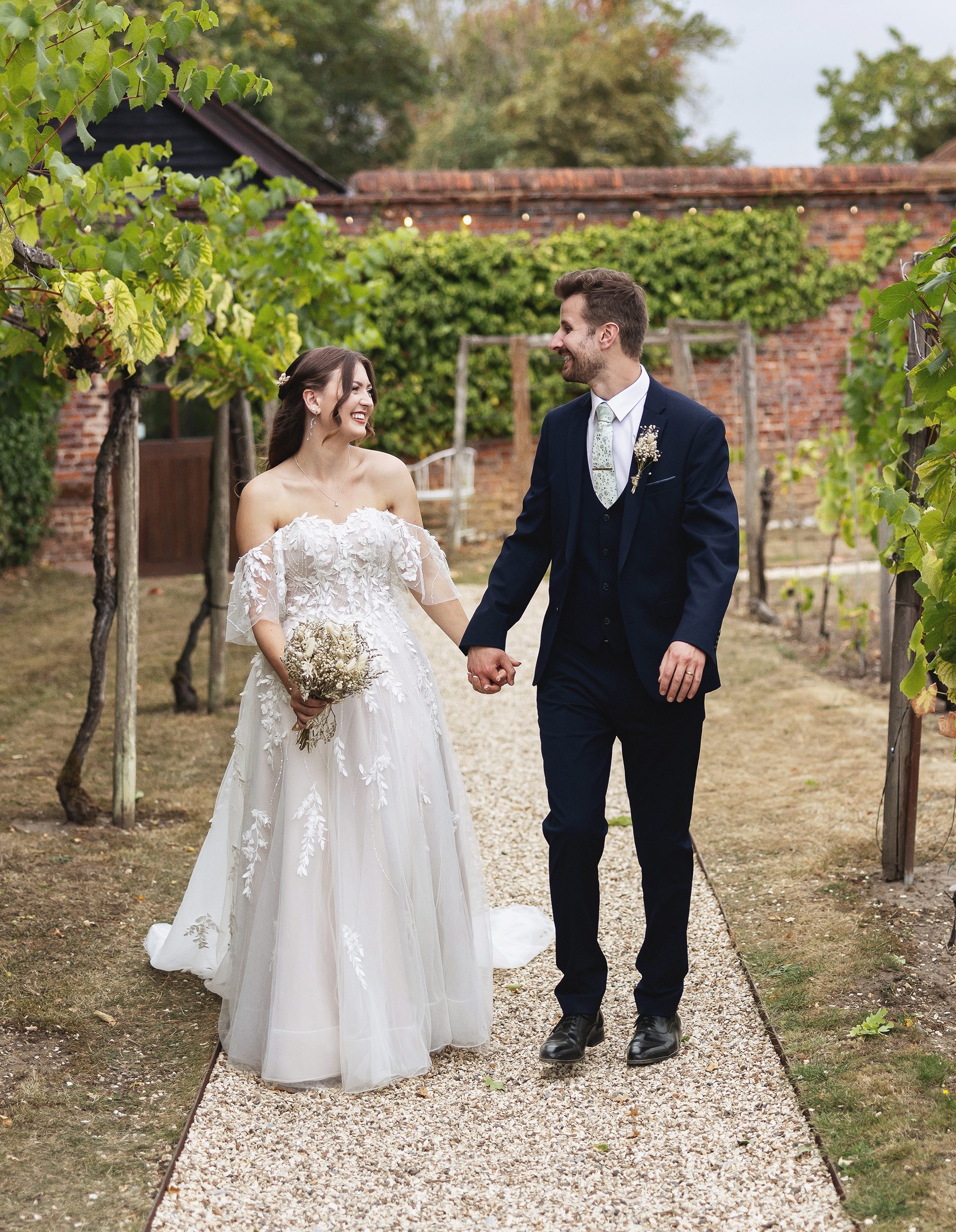 Bride and groom hand in hand Stanlake Park wedding