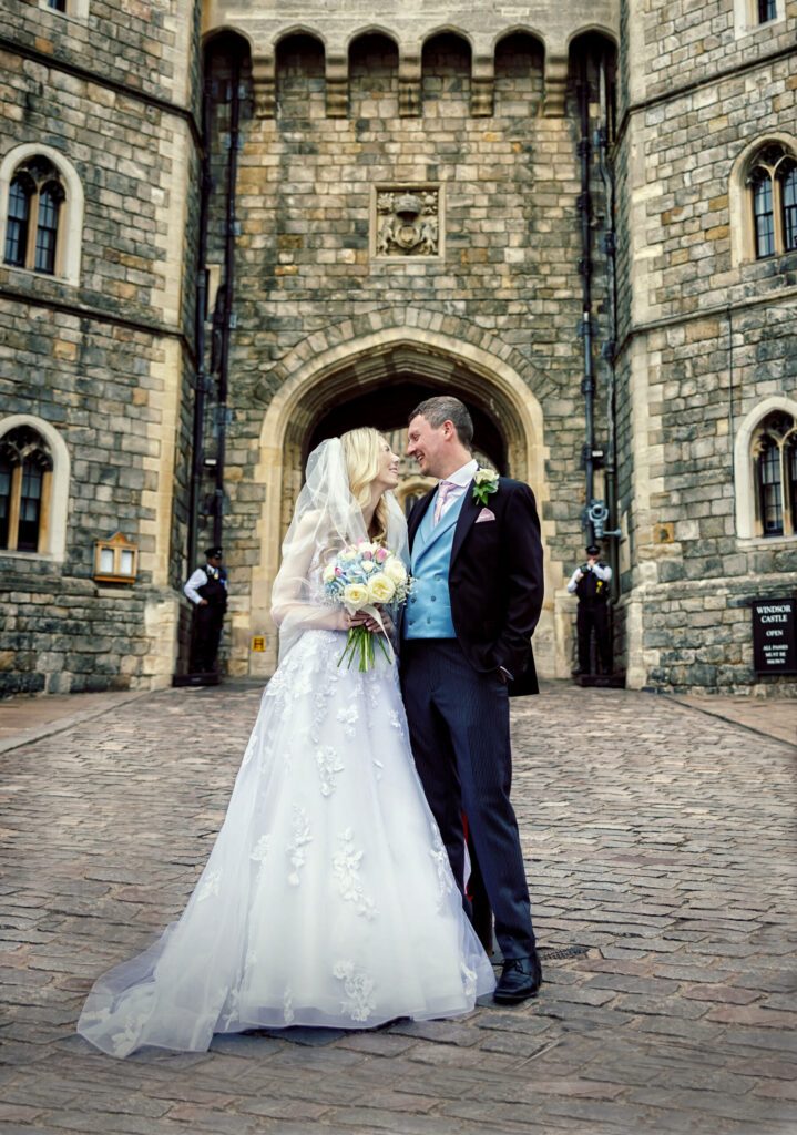Bride and groom in front of Windsor Castle after wedding