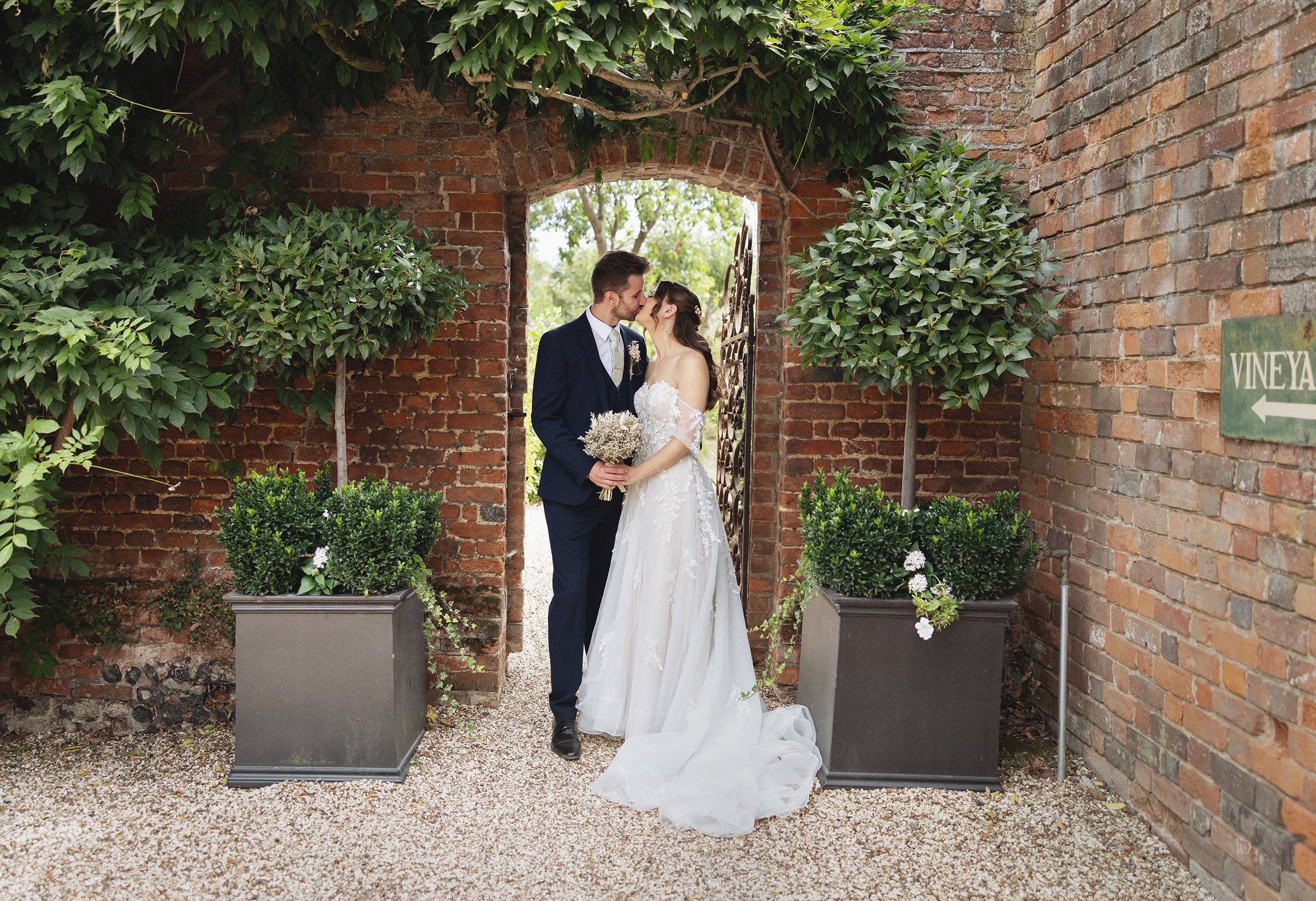 Bride and groom kiss in doorway Stanlake Park Wedding