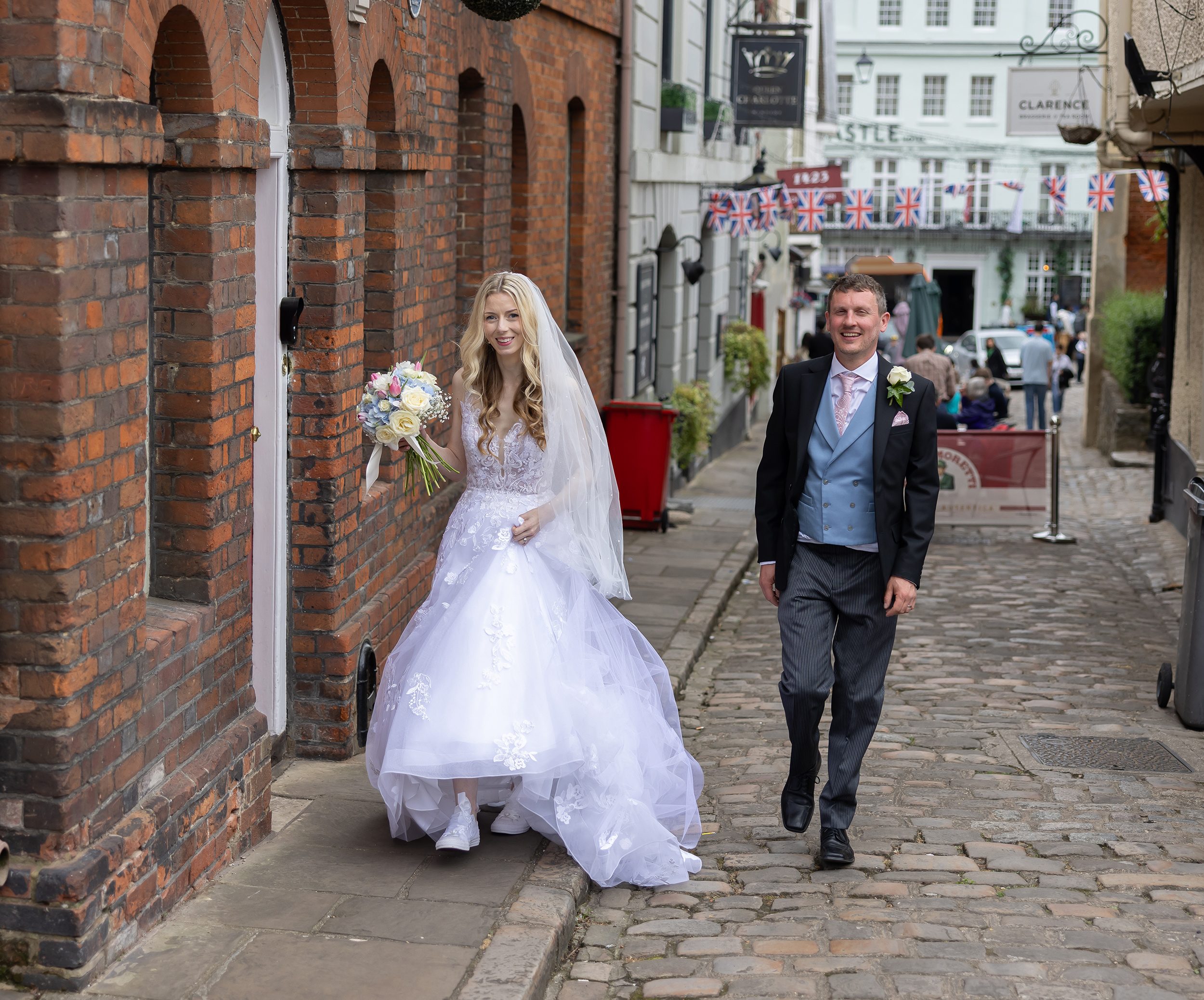 Bride and groom walk through streets of Windsor after wedding