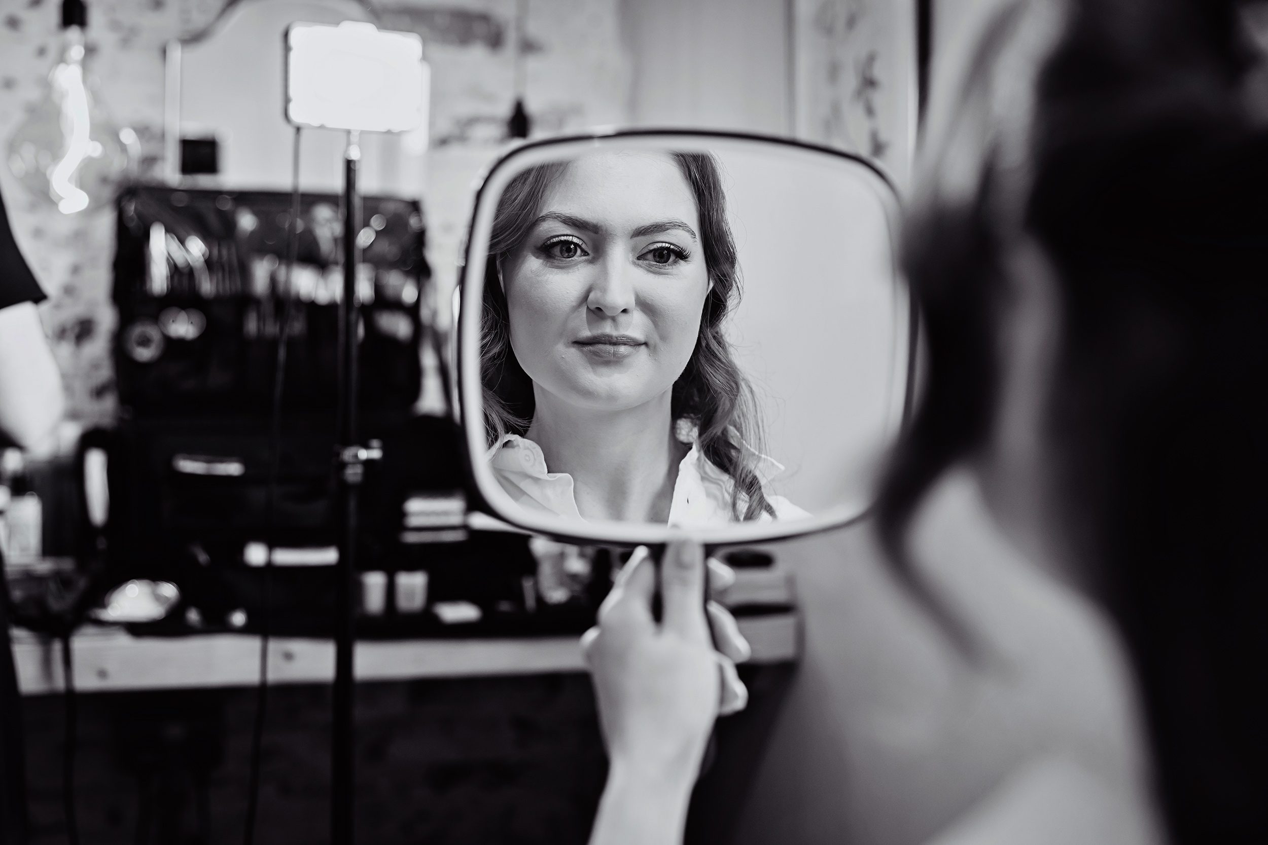 Bride in handheld mirror Stanlake Park wedding