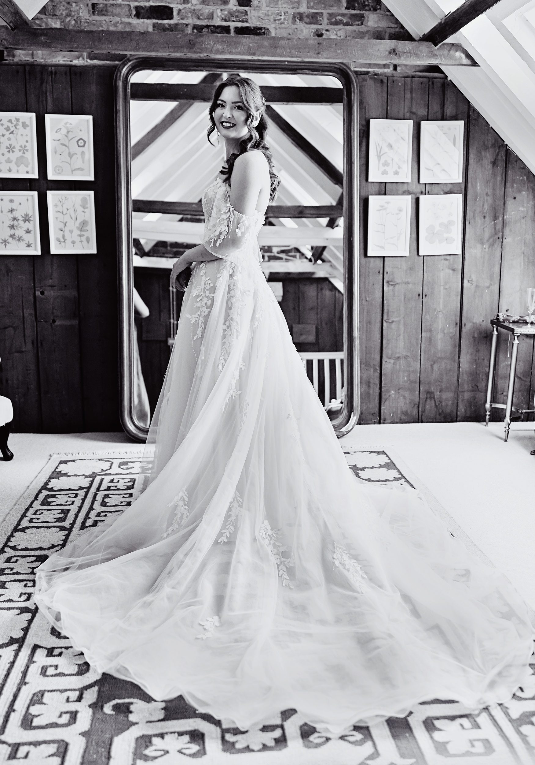 Bride in her wedding dress by mirror at Stanlake Park