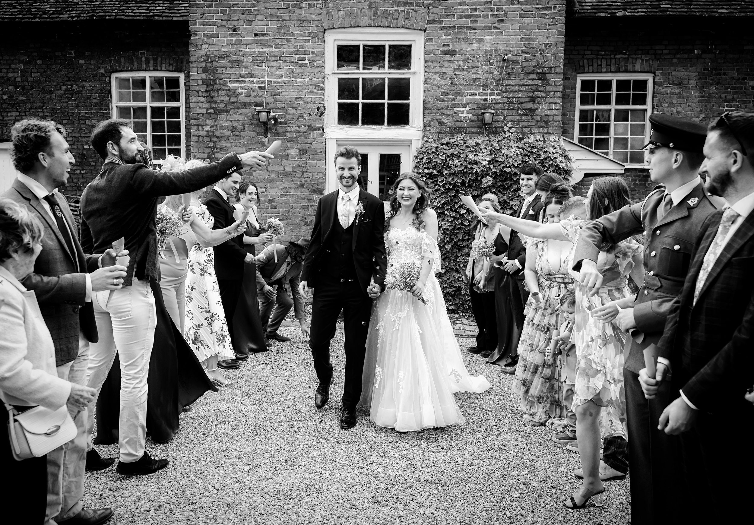 Confetti throw at Stanlake Park wedding BW
