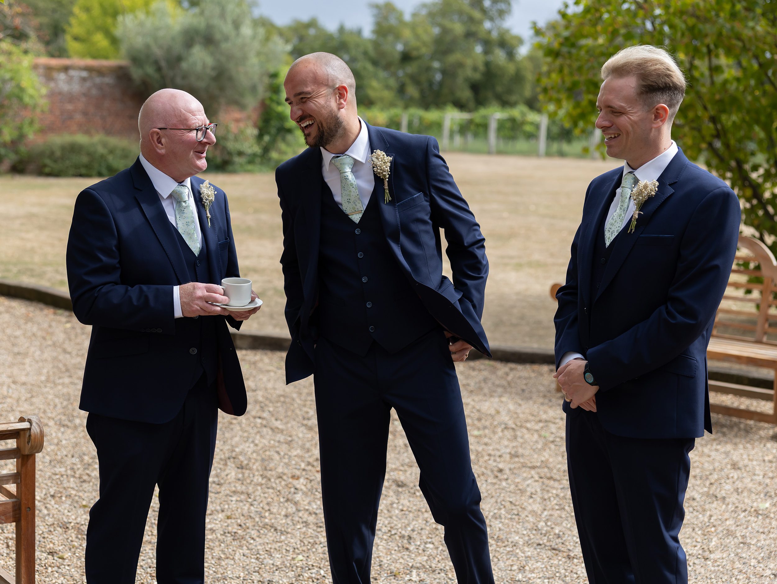 Groomsmen laughing together at Stanlake Park