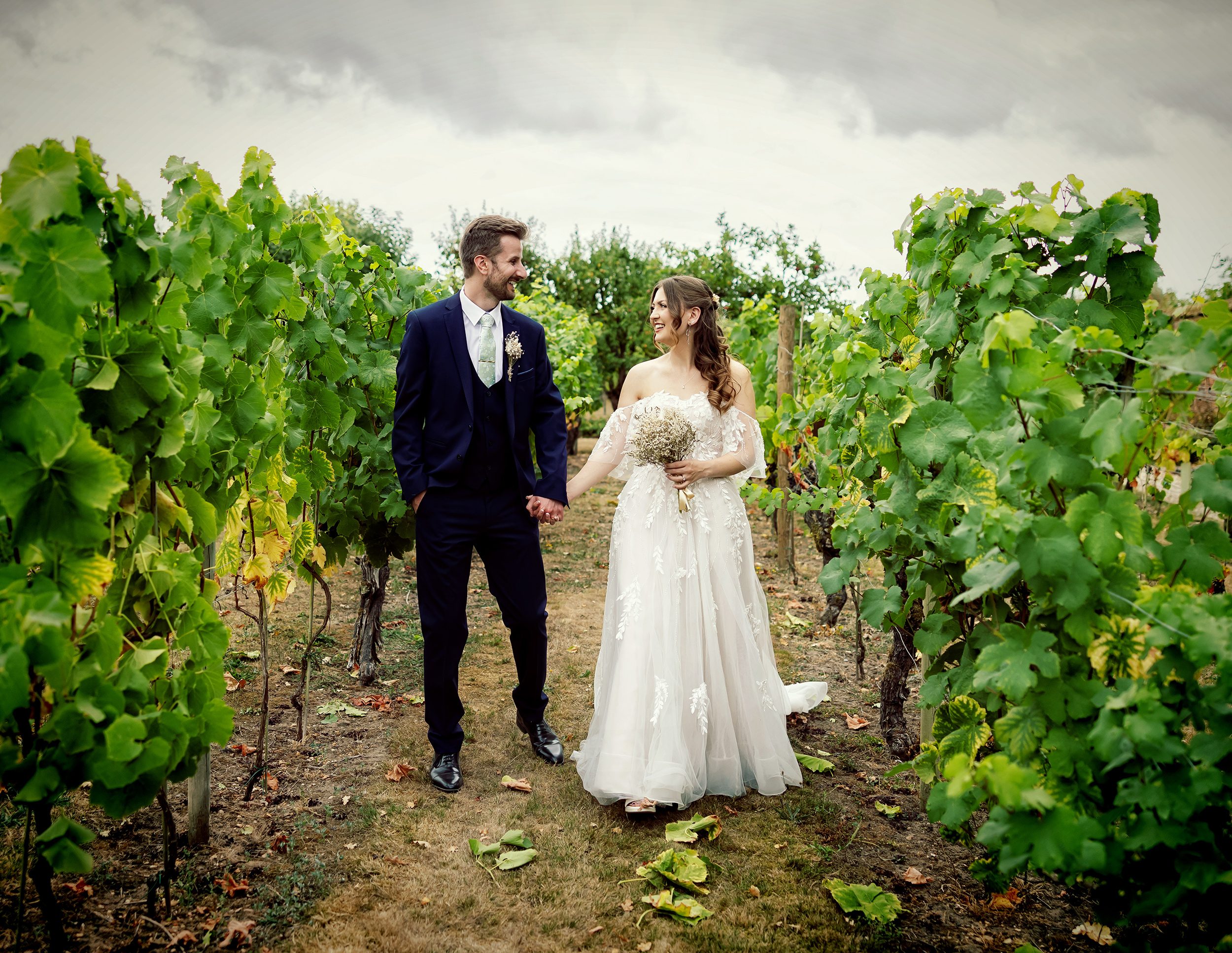 Stanlake Park Wedding bride and groom walking in vineyard