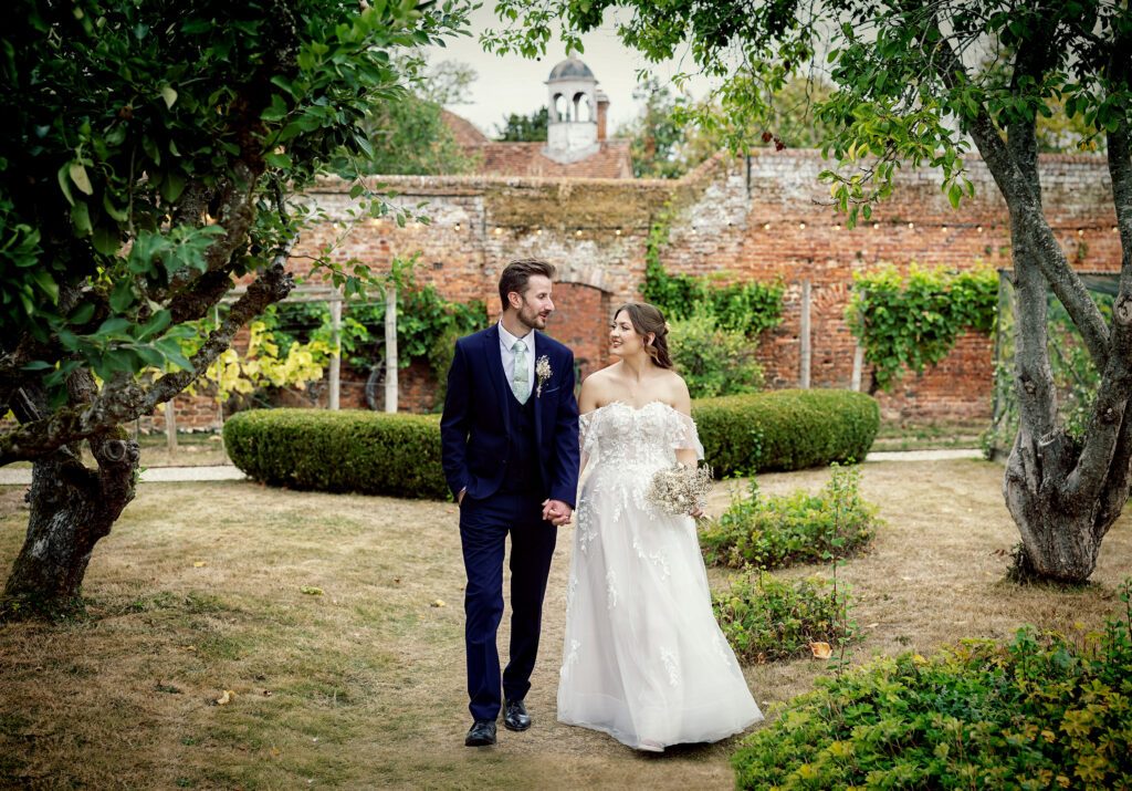 Stanlake Park Wedding bride and groom walking through grounds image