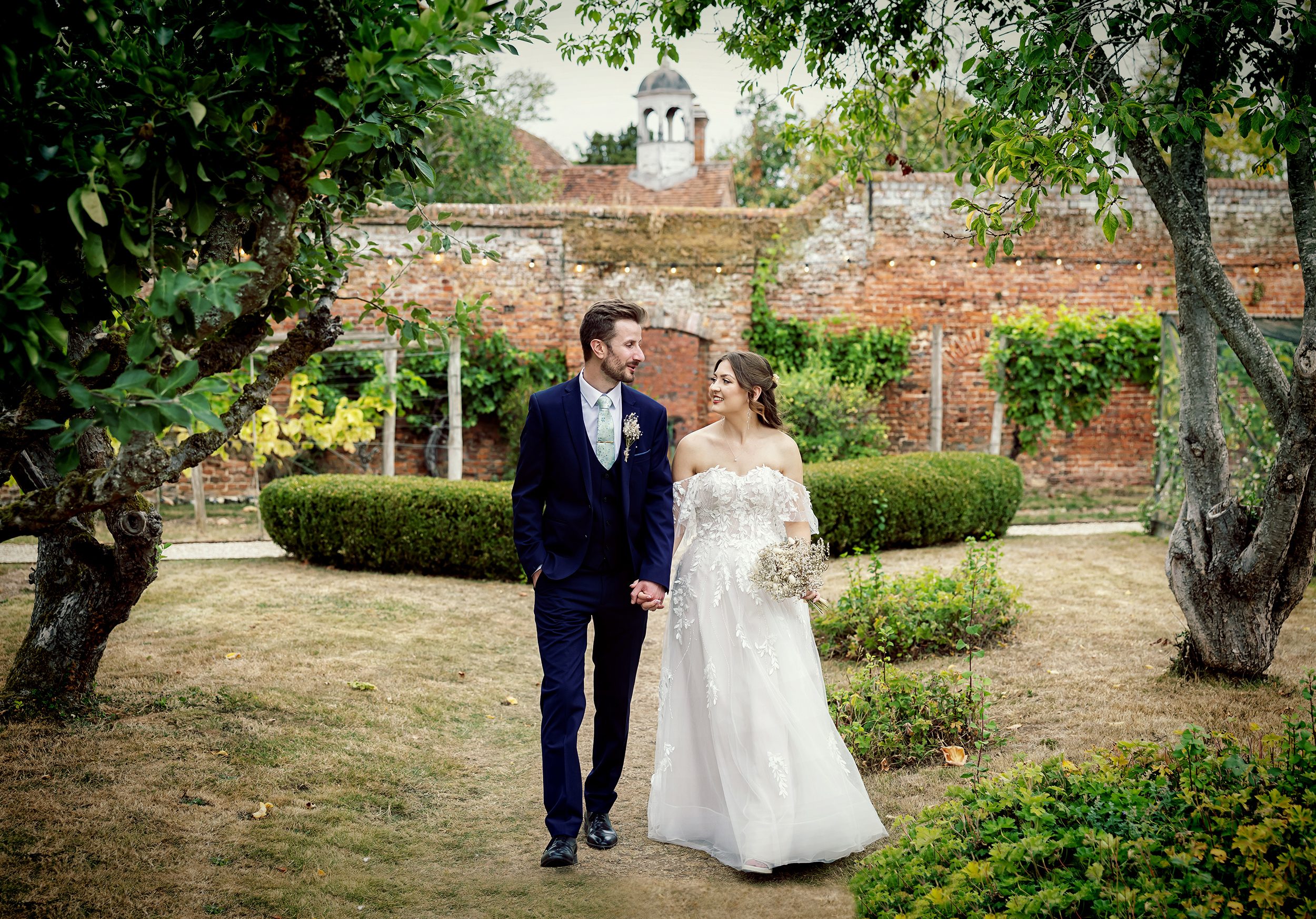 Stanlake Park Wedding bride and groom walking through grounds image