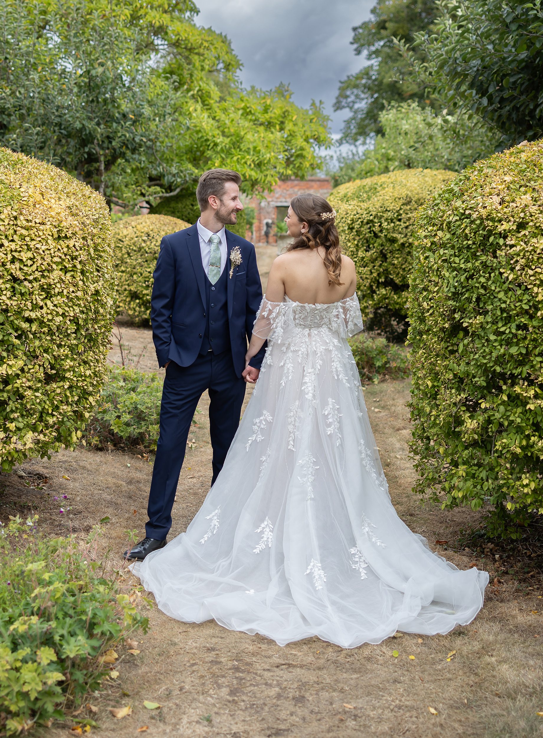 Stanlake Park wedding couple facing opposite ways in the grounds