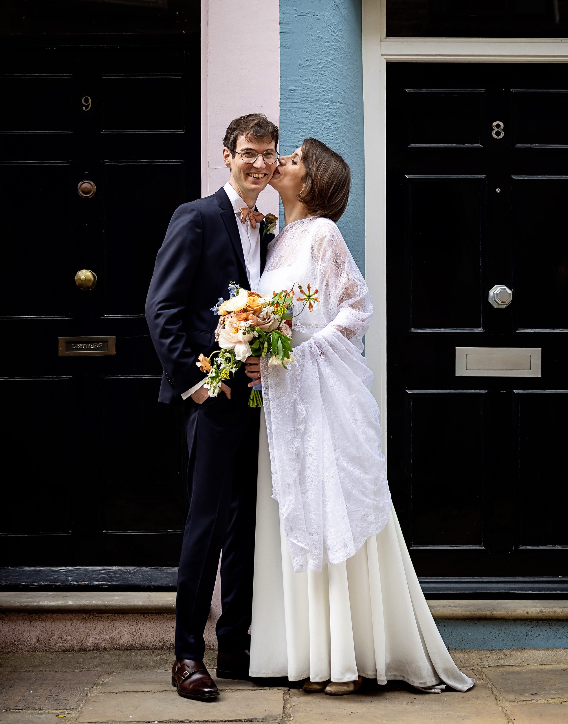 Bride and groom between front doors in Fitzrovia London